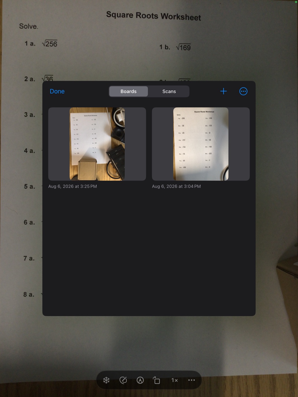 The Boards and Scans library open over the camera view, showing two saved worksheet boards with timestamps.